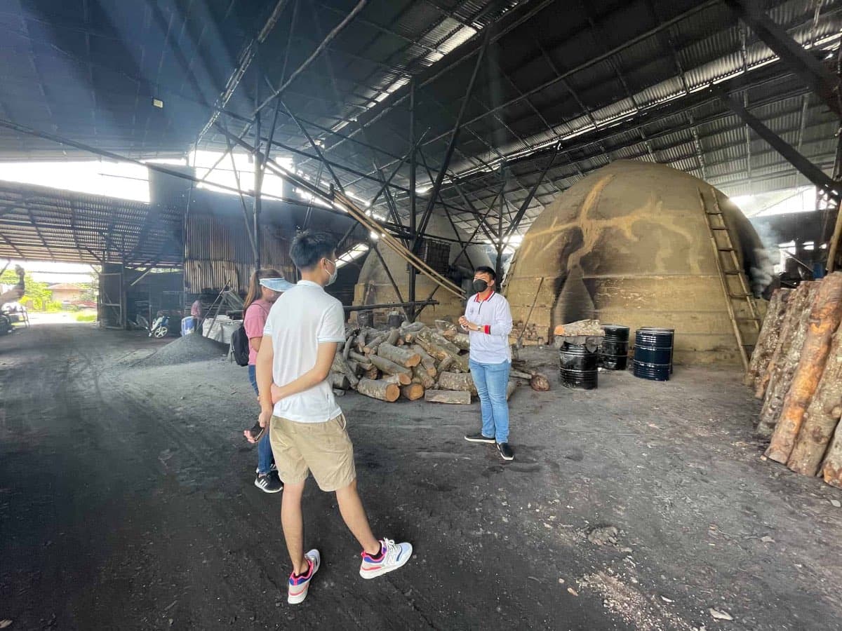 The manager is explaining the use of the kilns