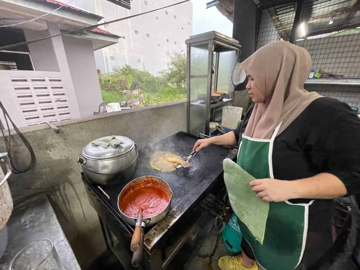 The cook is preparing our sambal grilled fish