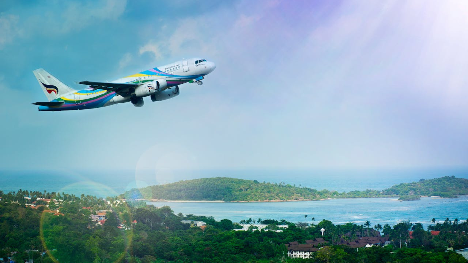 An aeroplane flying against a blue sky backdrop